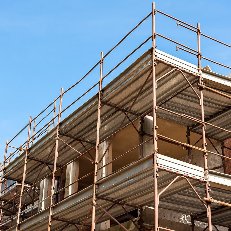 House for renovation with the scaffolding for bricklayers House for renovation with the scaffolding for bricklayers